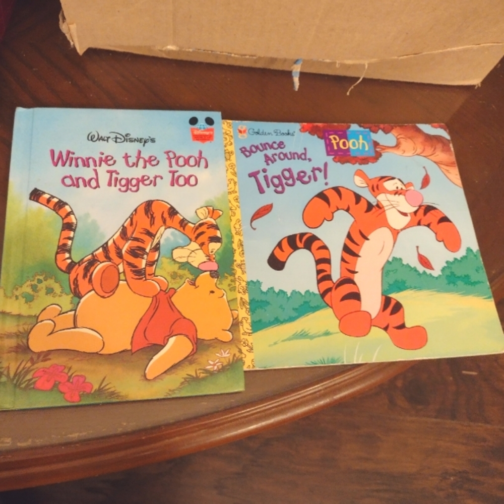 Winnie the Pooh Tigger books.One hard cover and one soft cover book